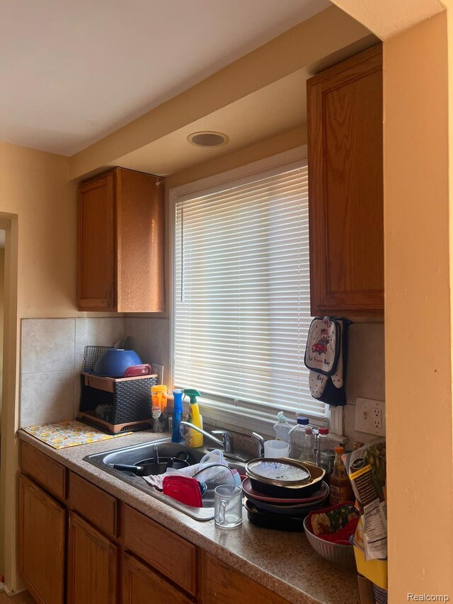 9910 Coyle St, Detroit, MI 48227 - kitchen with brown cabinets and a sink