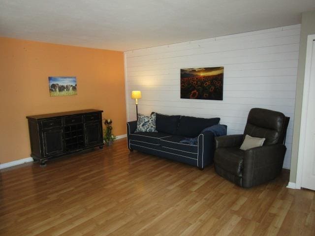 2024 Hamilton St, Okemos, MI 48864 - living area with wood finished floors, wood walls, and baseboards