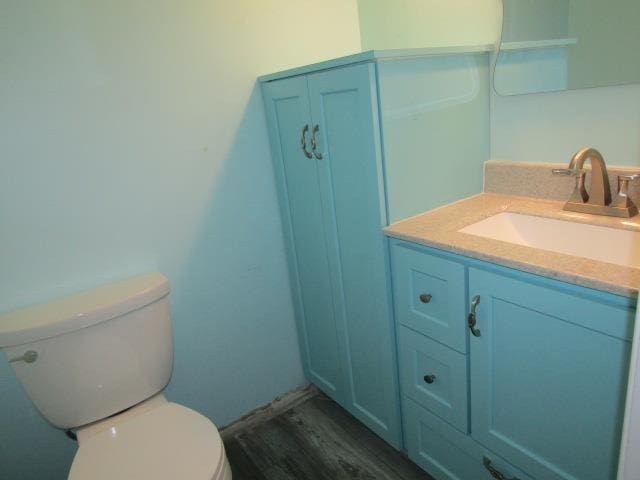 2024 Hamilton St, Okemos, MI 48864 - half bathroom featuring toilet, vanity, and wood finished floors