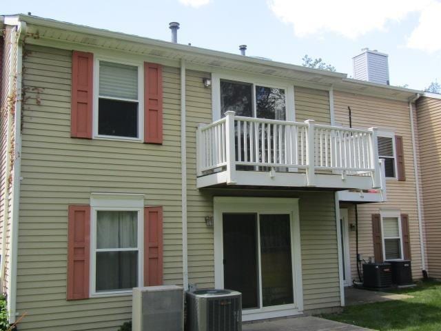 2024 Hamilton St, Okemos, MI 48864 - back of property featuring a balcony, cooling unit, and a chimney