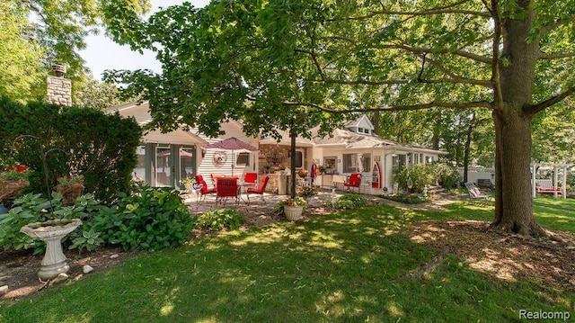 1786 Point St, Commerce Twp, MI 48382 - rear view of house with a patio, a yard, and a chimney