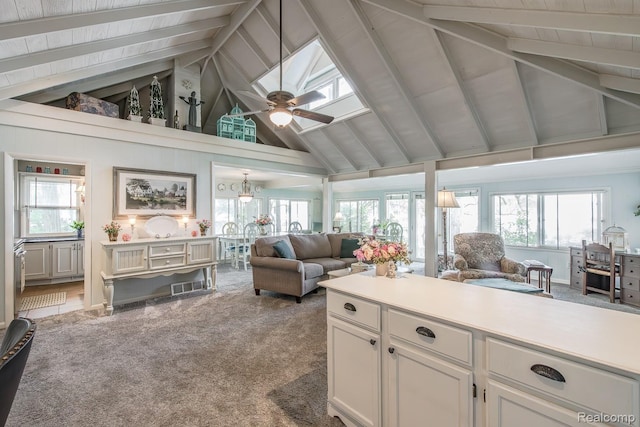 1786 Point St, Commerce Twp, MI 48382 - carpeted living area with high vaulted ceiling, beam ceiling, plenty of natural light, and a ceiling fan