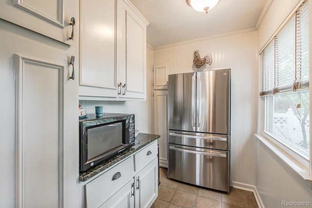 1786 Point St, Commerce Twp, MI 48382 - kitchen with freestanding refrigerator, black microwave, white cabinetry, ornamental molding, and dark stone counters