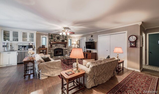 1786 Point St, Commerce Twp, MI 48382 - living room with dark wood-style floors, crown molding, ceiling fan, and a stone fireplace