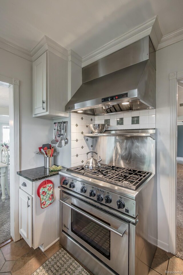 1786 Point St, Commerce Twp, MI 48382 - kitchen with wall chimney exhaust hood, high end stainless steel range oven, ornamental molding, tasteful backsplash, and white cabinetry