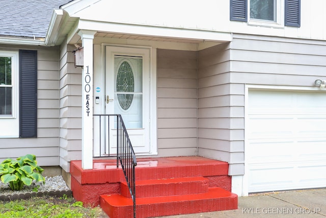 100 E 35th St, Holland, MI 49423 - view of exterior entry with a shingled roof and an attached garage