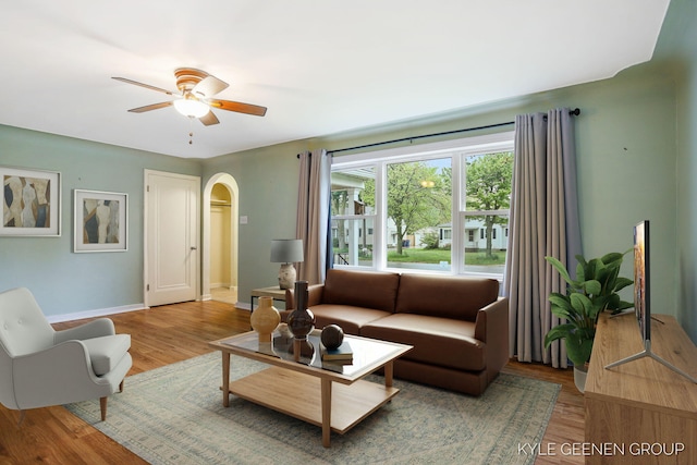 100 E 35th St, Holland, MI 49423 - living area featuring arched walkways, wood finished floors, a ceiling fan, and baseboards