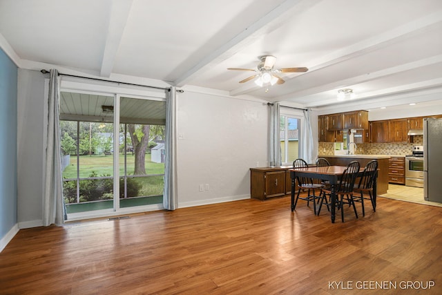 100 E 35th St, Holland, MI 49423 - dining room with beam ceiling, a ceiling fan, light wood-style floors, and baseboards