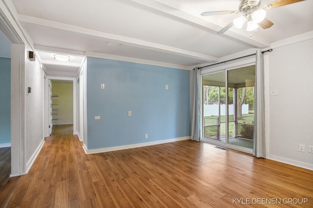 100 E 35th St, Holland, MI 49423 - empty room with beamed ceiling, wood finished floors, baseboards, and a ceiling fan