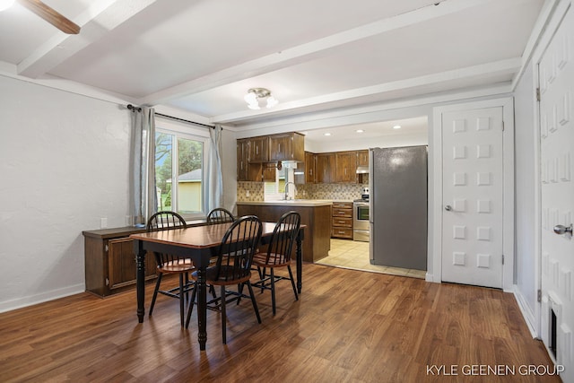 100 E 35th St, Holland, MI 49423 - dining space with beam ceiling, wood finished floors, and baseboards