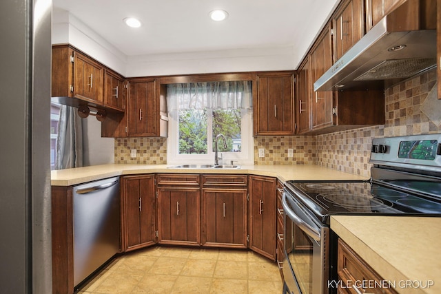 100 E 35th St, Holland, MI 49423 - kitchen featuring appliances with stainless steel finishes, range hood, a sink, light countertops, and recessed lighting