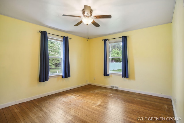 100 E 35th St, Holland, MI 49423 - spare room with plenty of natural light, hardwood / wood-style flooring, a ceiling fan, and baseboards