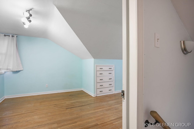 100 E 35th St, Holland, MI 49423 - additional living space with lofted ceiling, light wood-style floors, and baseboards