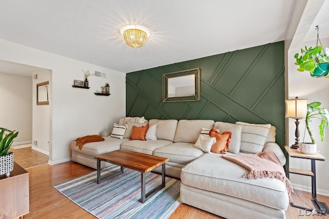 431 Meadowbrook Dr, Adrian, MI 49221 - living area with a decorative wall, baseboards, light wood-style floors, and an accent wall