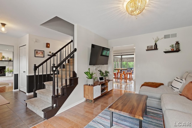 431 Meadowbrook Dr, Adrian, MI 49221 - living room featuring stairway, wood finished floors, and baseboards