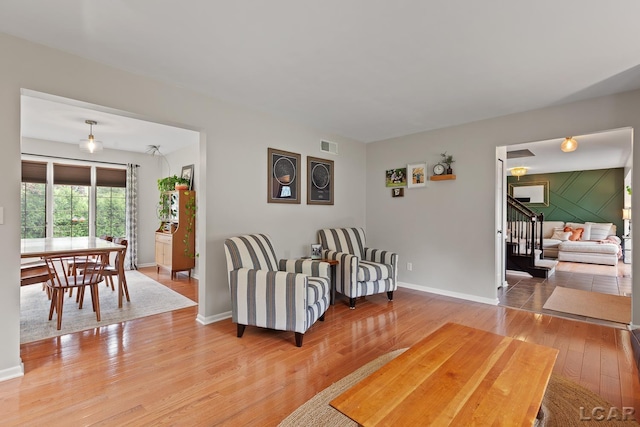 431 Meadowbrook Dr, Adrian, MI 49221 - living room featuring light wood finished floors, stairway, and baseboards