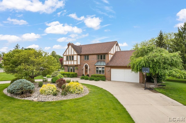431 Meadowbrook Dr, Adrian, MI 49221 - english style home featuring concrete driveway, an attached garage, a front lawn, brick siding, and board and batten siding