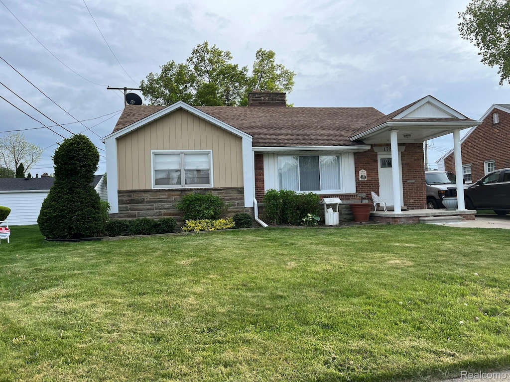 1784 Sherwood Ct, Dearborn, MI 48124 - view of front of property with a chimney, a front yard, roof with shingles, board and batten siding, and stone siding
