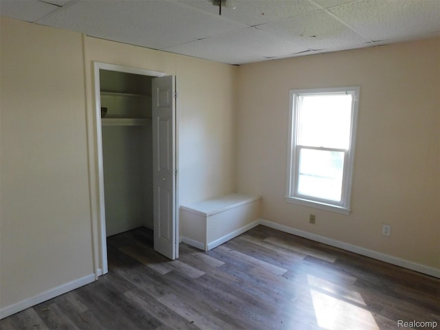 710 Washington St, Algonac, MI 48001 - unfurnished bedroom with wood finished floors, baseboards, a paneled ceiling, and a closet