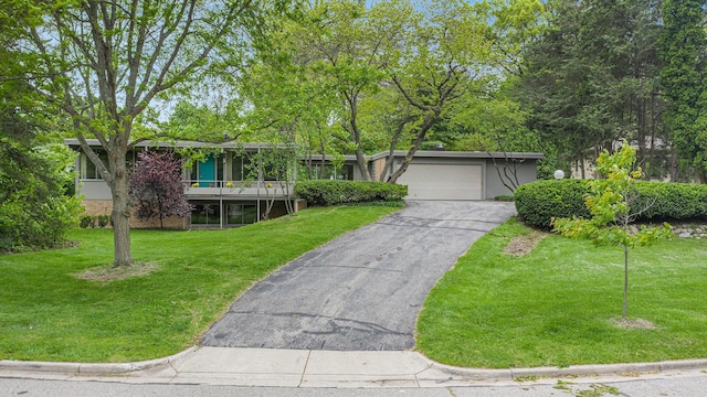 19 Heatheridge St, Ann Arbor, MI 48104 - mid-century inspired home featuring an attached garage, a front yard, and asphalt driveway