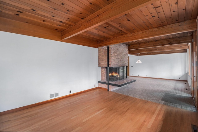 19 Heatheridge St, Ann Arbor, MI 48104 - unfurnished living room featuring baseboards, a fireplace, wood finished floors, and wood ceiling with exposed beams