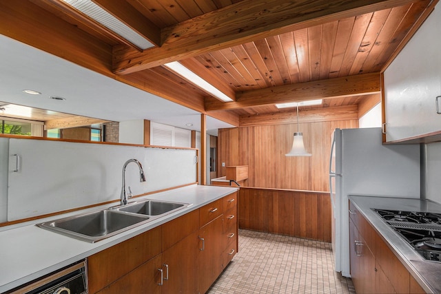19 Heatheridge St, Ann Arbor, MI 48104 - kitchen featuring stovetop with downdraft, wooden walls, a sink, wooden ceiling with exposed beams, and light tile patterned flooring