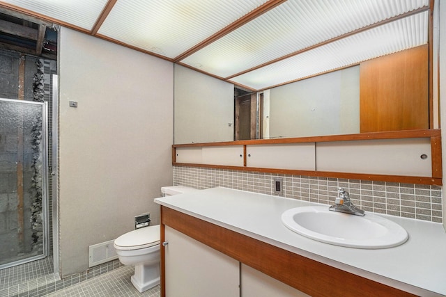 19 Heatheridge St, Ann Arbor, MI 48104 - full bathroom with toilet, tile patterned floors, a stall shower, vanity, and decorative backsplash