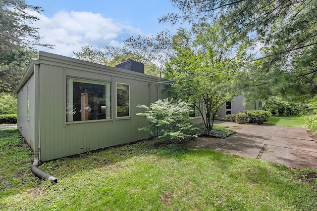 19 Heatheridge St, Ann Arbor, MI 48104 - view of home's exterior with a lawn, a patio area, and a chimney