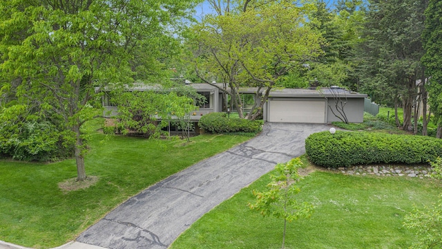 19 Heatheridge St, Ann Arbor, MI 48104 - view of front of property with asphalt driveway, an attached garage, and a front yard