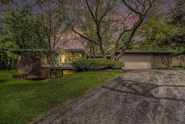 19 Heatheridge St, Ann Arbor, MI 48104 - mid-century inspired home with asphalt driveway, a front lawn, and a garage