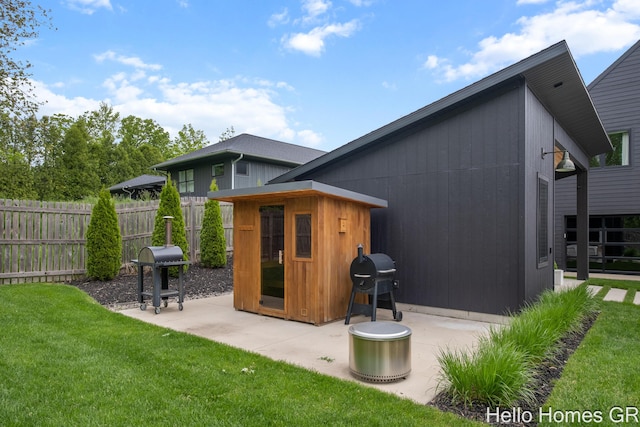 421 Manhattan Rd SE, Grand Rapids, MI 49506 - rear view of property featuring an outdoor structure and a patio area