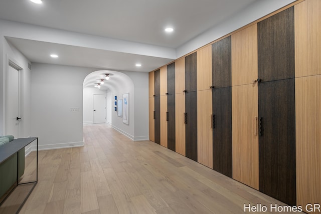 421 Manhattan Rd SE, Grand Rapids, MI 49506 - hall featuring arched walkways, light wood finished floors, recessed lighting, and baseboards