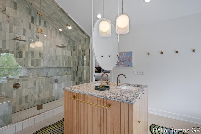 421 Manhattan Rd SE, Grand Rapids, MI 49506 - full bathroom featuring a tile shower, vanity, vaulted ceiling, tile patterned floors, and baseboards