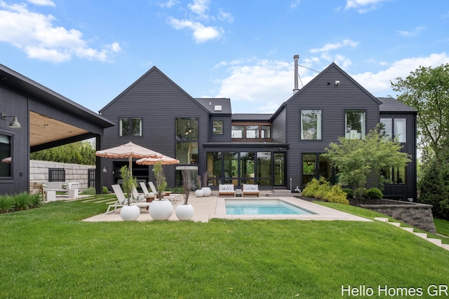 421 Manhattan Rd SE, Grand Rapids, MI 49506 - back of property featuring a patio, a lawn, an outdoor pool, and a sunroom