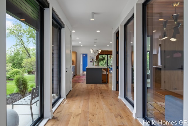 421 Manhattan Rd SE, Grand Rapids, MI 49506 - corridor featuring light wood finished floors, healthy amount of natural light, and recessed lighting