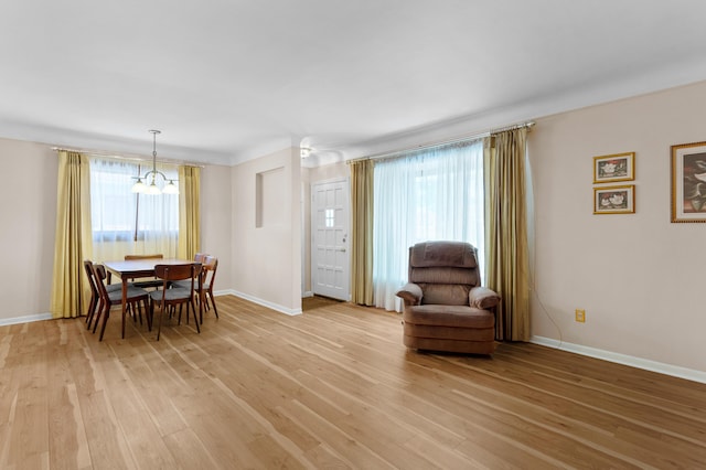 9085 Brentwood St, Livonia, MI 48150 - dining space with light wood-type flooring, a chandelier, and baseboards