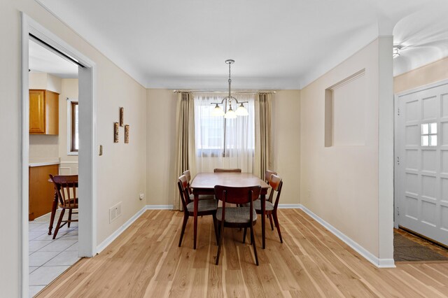 9085 Brentwood St, Livonia, MI 48150 - dining area featuring a chandelier, light wood-type flooring, and baseboards