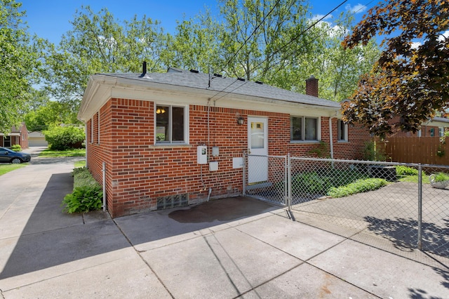 9085 Brentwood St, Livonia, MI 48150 - bungalow-style home with brick siding, a chimney, a gate, and driveway