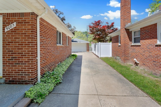 9085 Brentwood St, Livonia, MI 48150 - view of home's exterior featuring brick siding, a garage, and an outbuilding