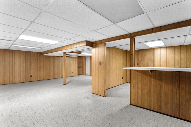 9085 Brentwood St, Livonia, MI 48150 - finished below grade area featuring a paneled ceiling, wood walls, and light flooring