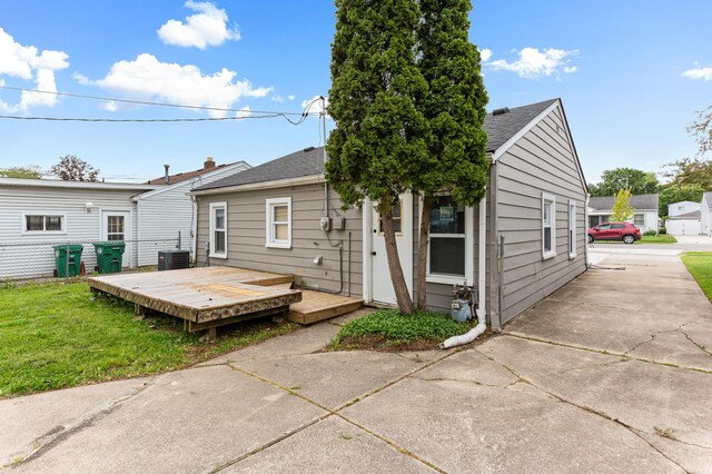 28506 Donnelly St, Garden City, MI 48135 - back of property featuring a deck, central AC unit, a yard, a shingled roof, and concrete driveway