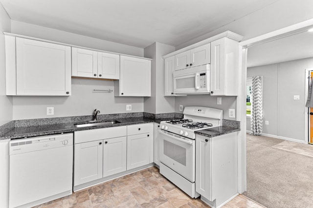 28506 Donnelly St, Garden City, MI 48135 - kitchen with white appliances, a sink, white cabinets, dark stone countertops, and baseboards