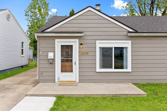 28506 Donnelly St, Garden City, MI 48135 - entrance to property with a shingled roof and a patio