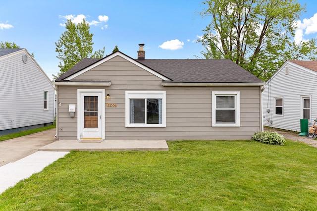 28506 Donnelly St, Garden City, MI 48135 - view of front of house featuring a chimney, roof with shingles, a front lawn, and a patio