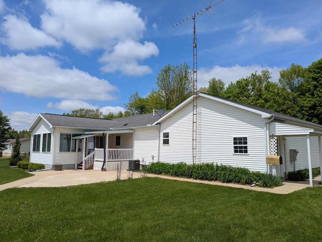 10639 Hanover Rd, Hanover, MI 49241 - rear view of house with a yard, a patio area, central AC, and concrete driveway