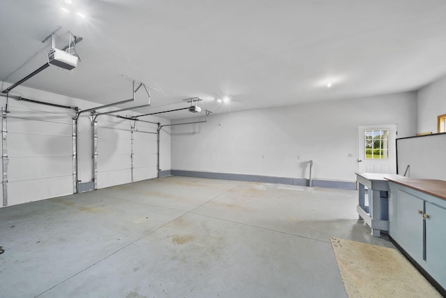 10639 Hanover Rd, Hanover, MI 49241 - garage with a garage door opener and baseboards