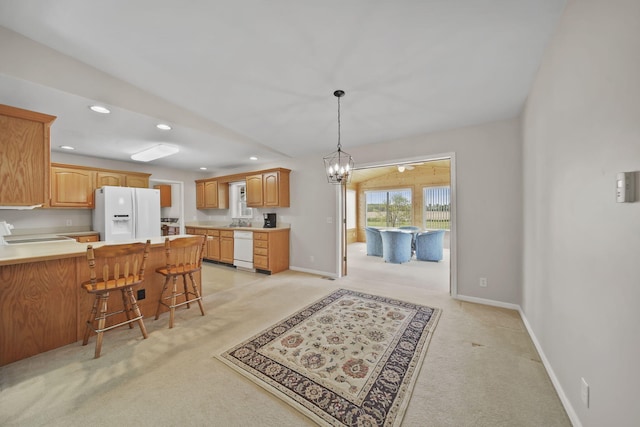 10639 Hanover Rd, Hanover, MI 49241 - kitchen with white appliances, light colored carpet, a peninsula, recessed lighting, and a kitchen bar