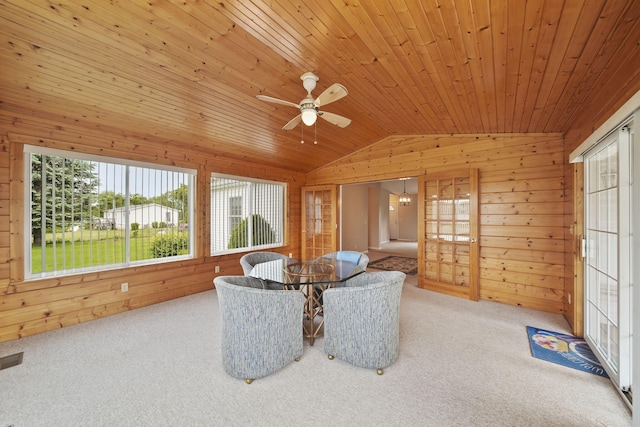 10639 Hanover Rd, Hanover, MI 49241 - carpeted dining space with wooden walls, plenty of natural light, lofted ceiling, wooden ceiling, and a ceiling fan