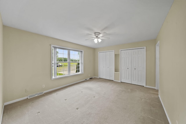 10639 Hanover Rd, Hanover, MI 49241 - unfurnished bedroom with two closets, baseboards, carpet floors, and a ceiling fan