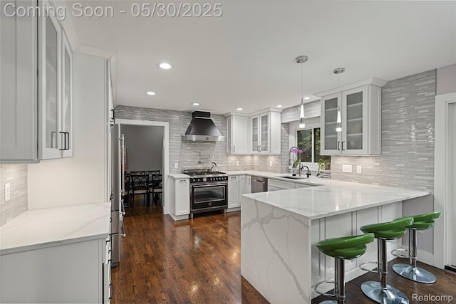 2640 Water Oaks Dr, West Bloomfield, MI 48324 - kitchen with ventilation hood, stainless steel appliances, a peninsula, backsplash, and recessed lighting